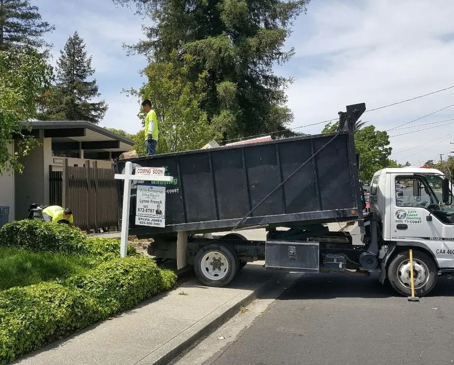 Left Coast Hauling truck loaded at a home cleanout