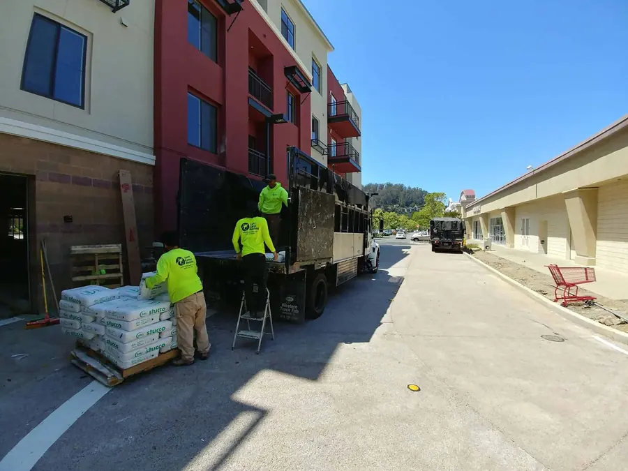 Left Coast crew in high-visibility shirts loading a truck
