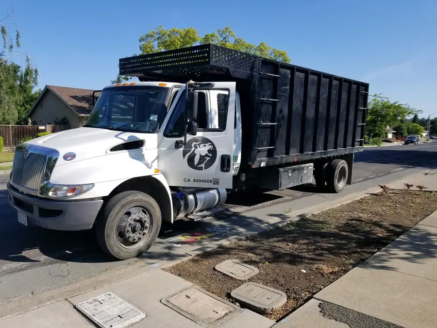 Left Coast Hauling dump truck on a residential street